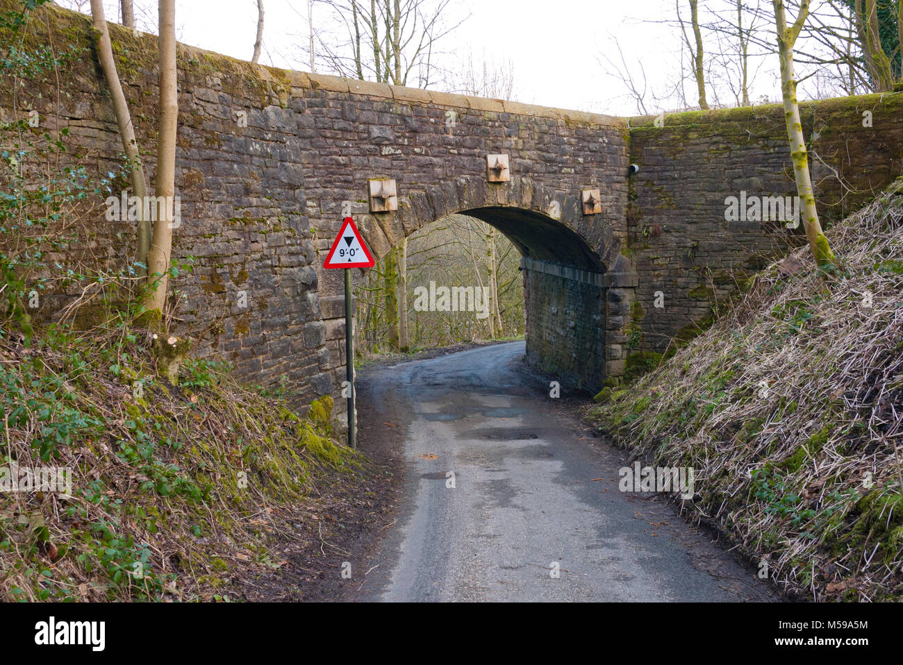 Height restriction sign by narrow stone bridge, Saddleworth, Greater Manchester, UK. Stock Photo