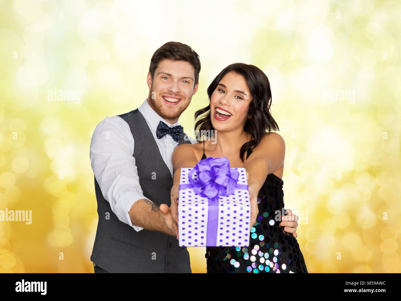 happy couple with gift box at birthday party Stock Photo - Alamy