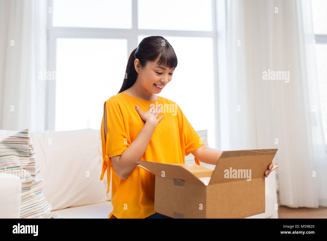 happy asian young woman with parcel box at home Stock Photo - Alamy