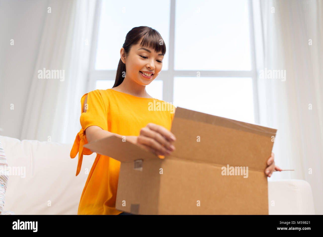 happy asian young woman with parcel box at home Stock Photo - Alamy