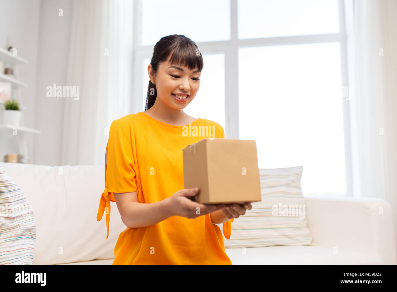 happy asian young woman with parcel box at home Stock Photo - Alamy