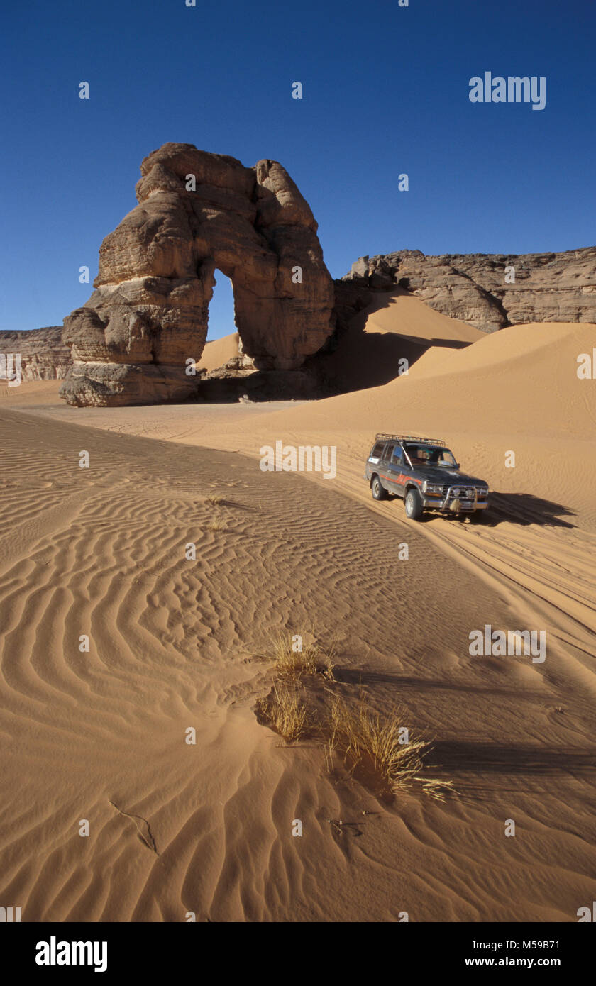 Libya. Near Ghat. Sahara desert. Akakus (Acacus) National Park. Natural arch called Fezzenger. 4x4 car. Stock Photo