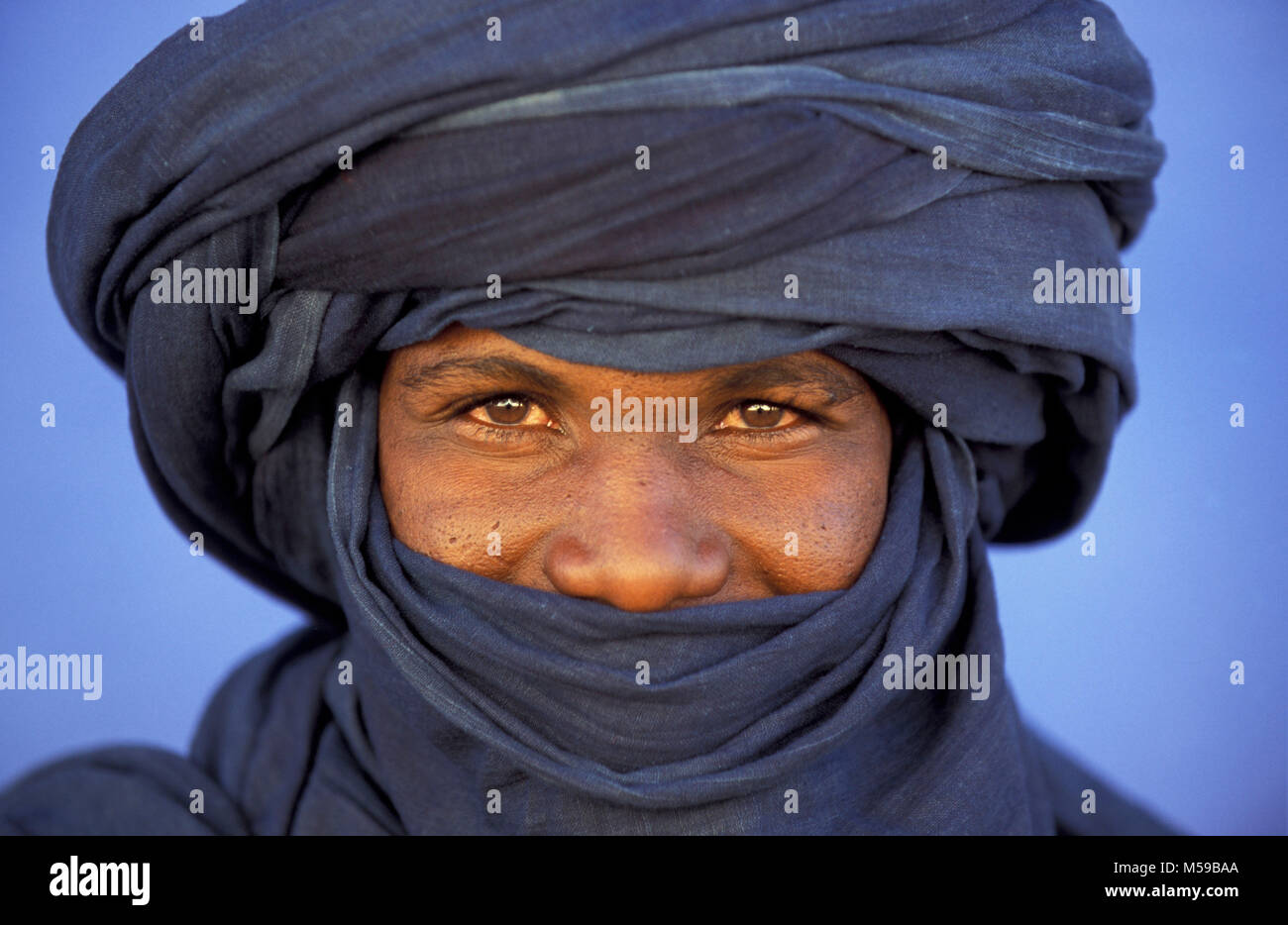 Libya. Ghat, Sahara desert. Man of Tuareg tribe wearing traditional headdress. Portrait. Stock Photo