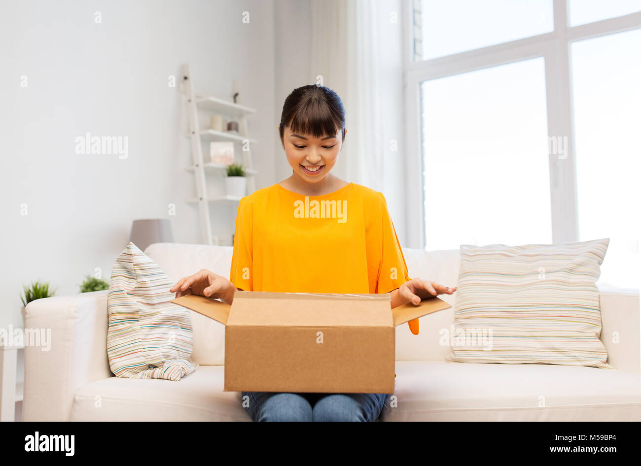 happy asian young woman with parcel box at home Stock Photo - Alamy