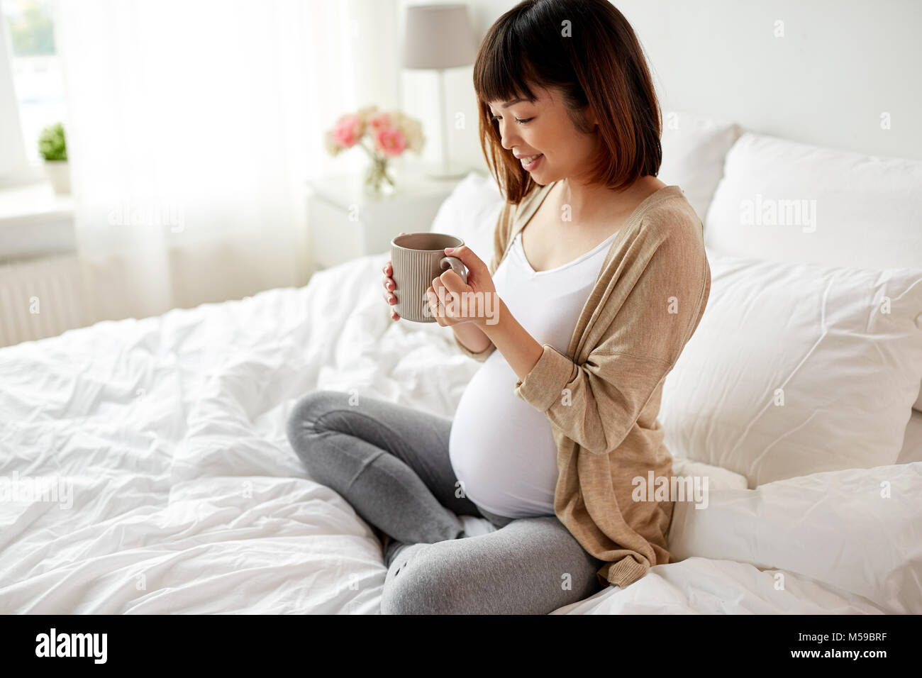 happy pregnant woman with cup drinking tea at home Stock Photo Alamy