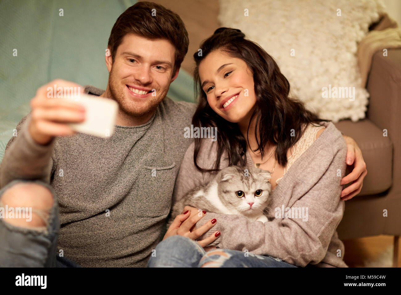 happy couple taking selfie by smartphone at home Stock Photo - Alamy