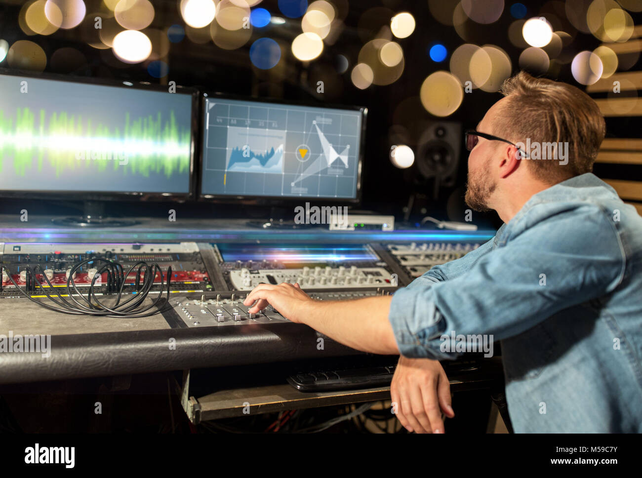 man at mixing console in music recording studio Stock Photo - Alamy