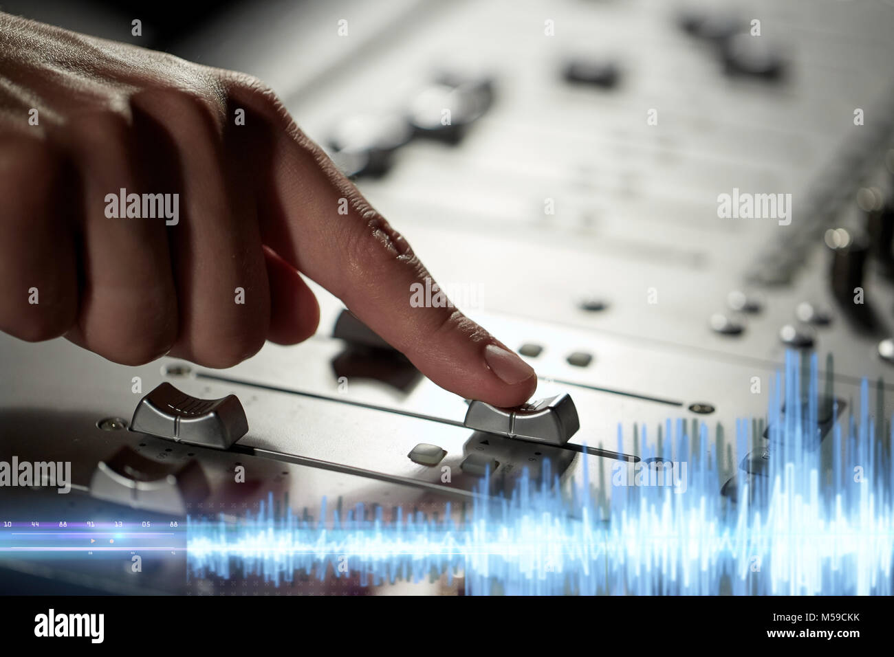 hand using mixing console for music recording Stock Photo