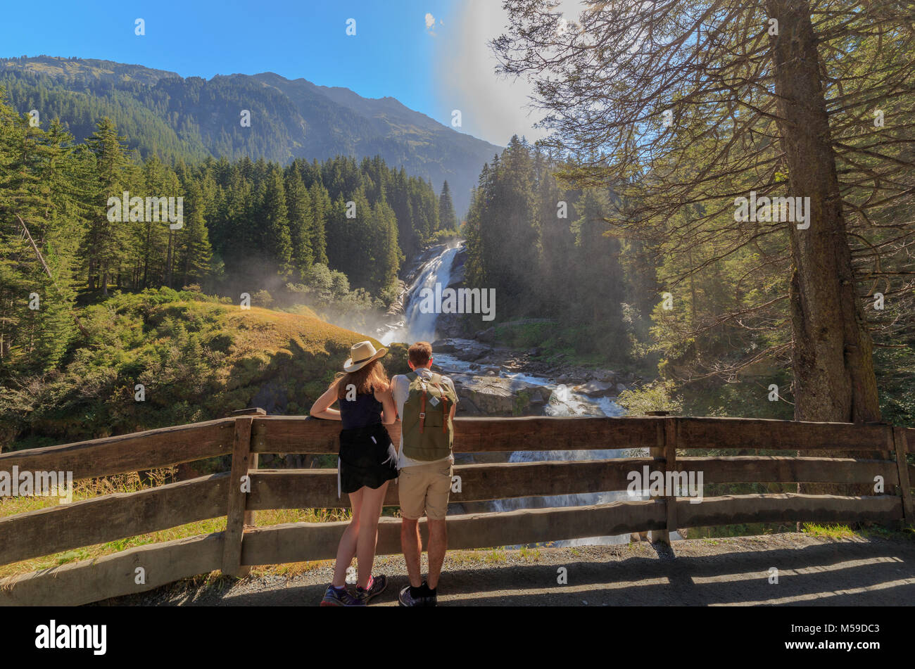 Young couple watching the Krimmler Waterfalls in summer Stock Photo
