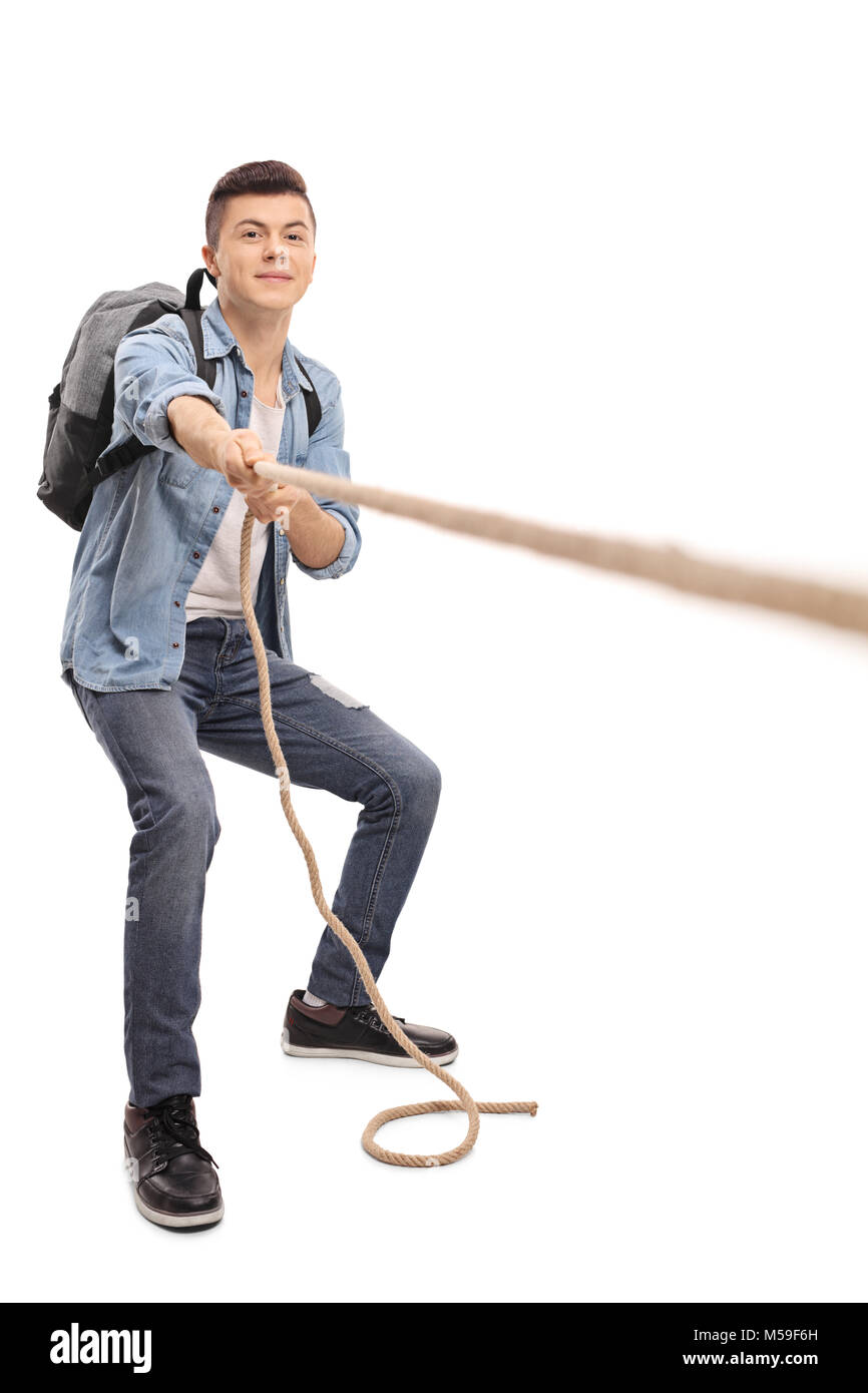 Full length portrait of a teenage student pulling a rope isolated on white background Stock Photo