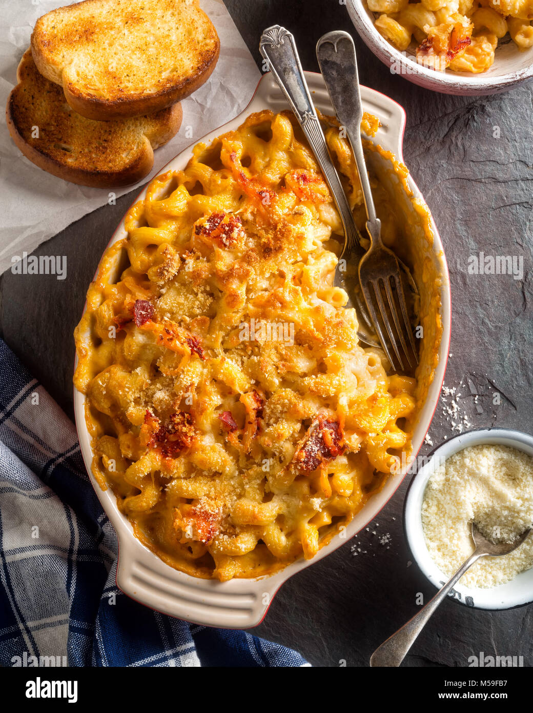 An overhead view of delicious lobster mac and cheese with toasted bread. Stock Photo