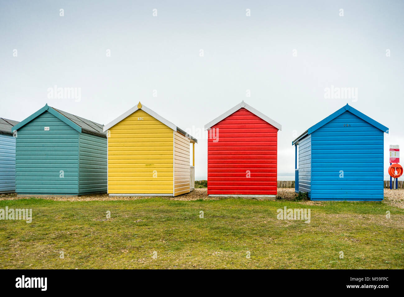 Colourful beach huts along Calshot Spit, Calshot, England, UK Stock Photo
