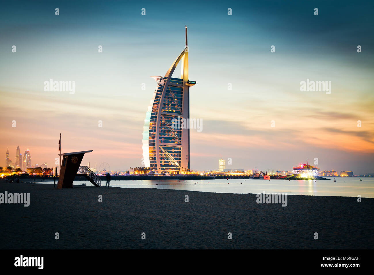 DUBAI, UAE - FEBRUARY 2018 :The world's first seven stars luxury hotel Burj Al Arab at night seen from Jumeirah public beach in Dubai, United Arab Emi Stock Photo