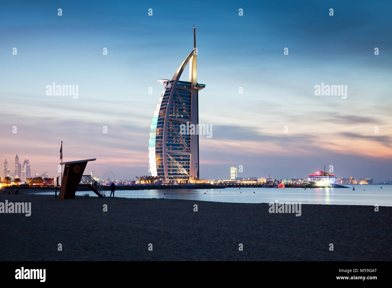 DUBAI, UAE - FEBRUARY 2018 :The world's first seven stars luxury hotel Burj Al Arab at night seen from Jumeirah public beach in Dubai, United Arab Emi Stock Photo