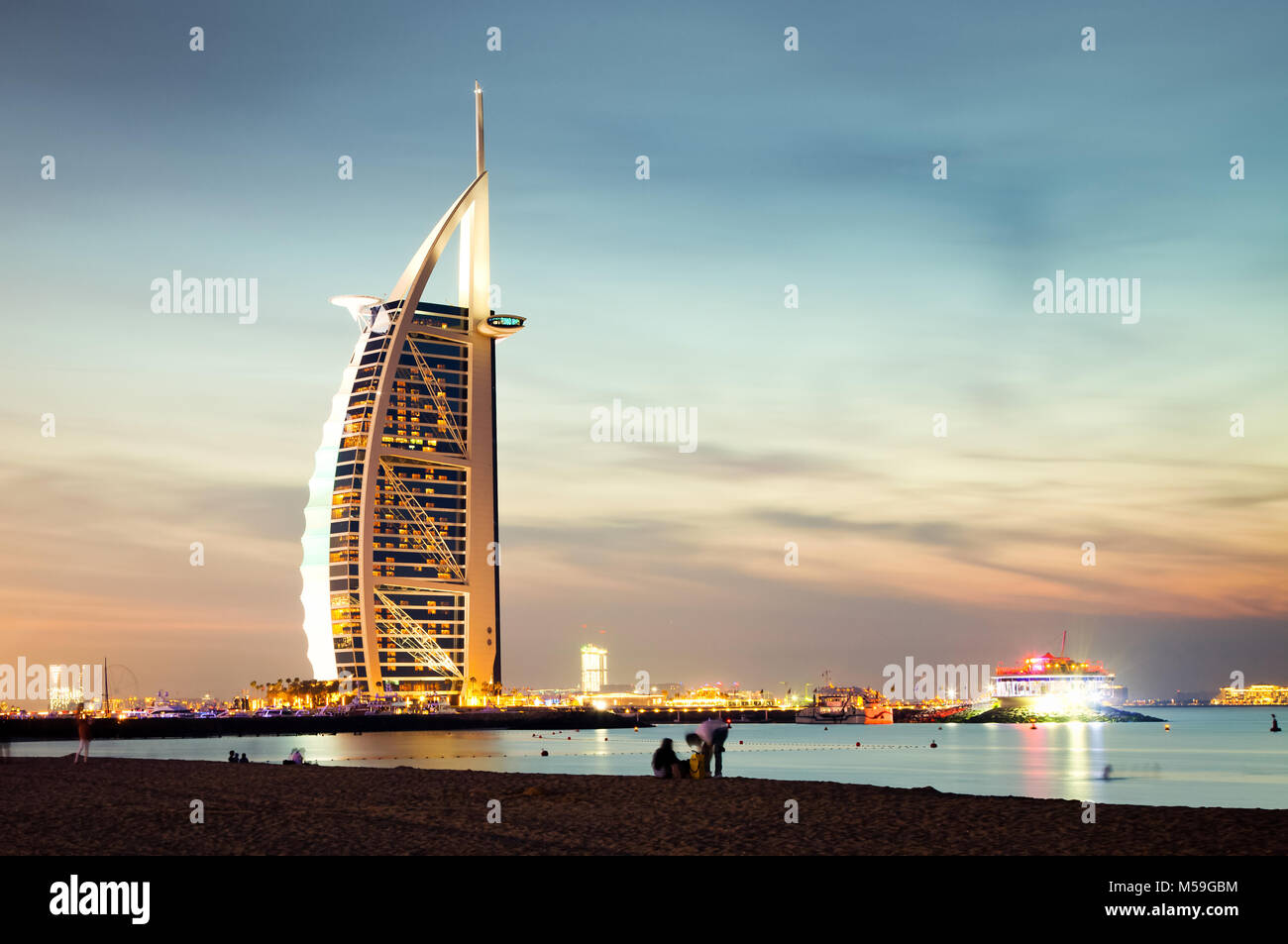 DUBAI, UAE - FEBRUARY 2018 :The world's first seven stars luxury hotel Burj Al Arab at night seen from Jumeirah public beach in Dubai, United Arab Emi Stock Photo