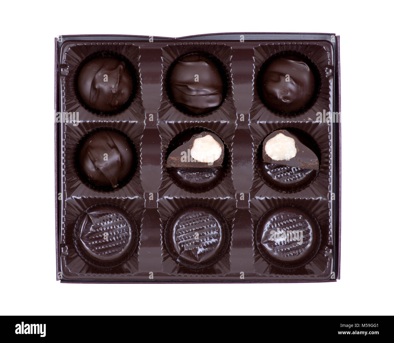 Dark chocolate covered macadamia nuts in plastic packaging Stock Photo