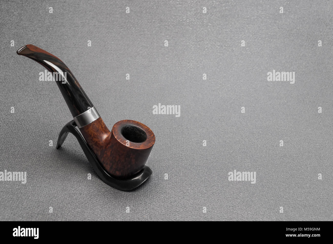 Briar Irish tobacco smoking pipe bent type made of heather on a stand