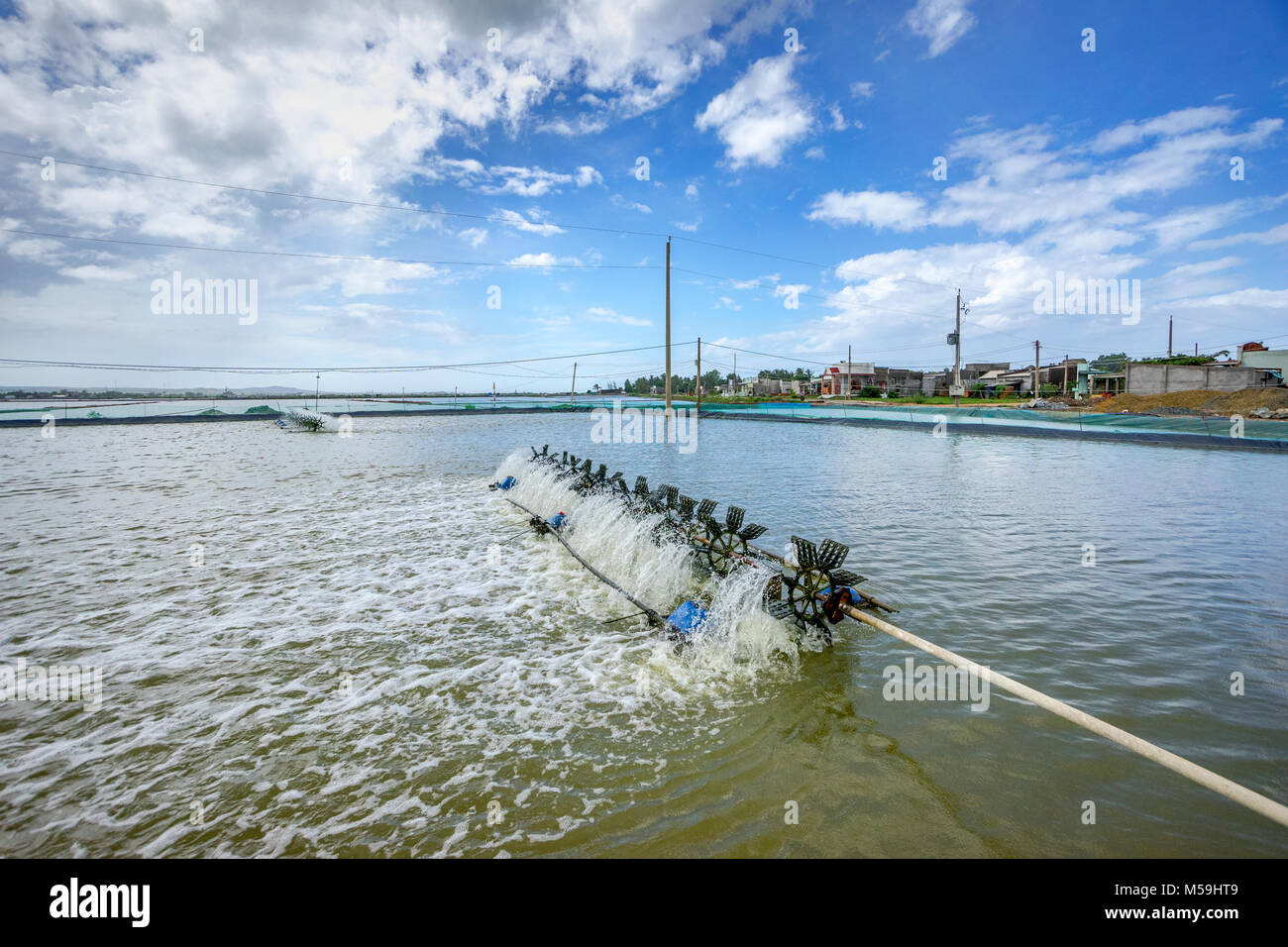 * Aerator turbine wheel oxygen fill ins Into lake water in Shrimp farm at Ba Ria, Vung Tau, Vietnam Stock Photo