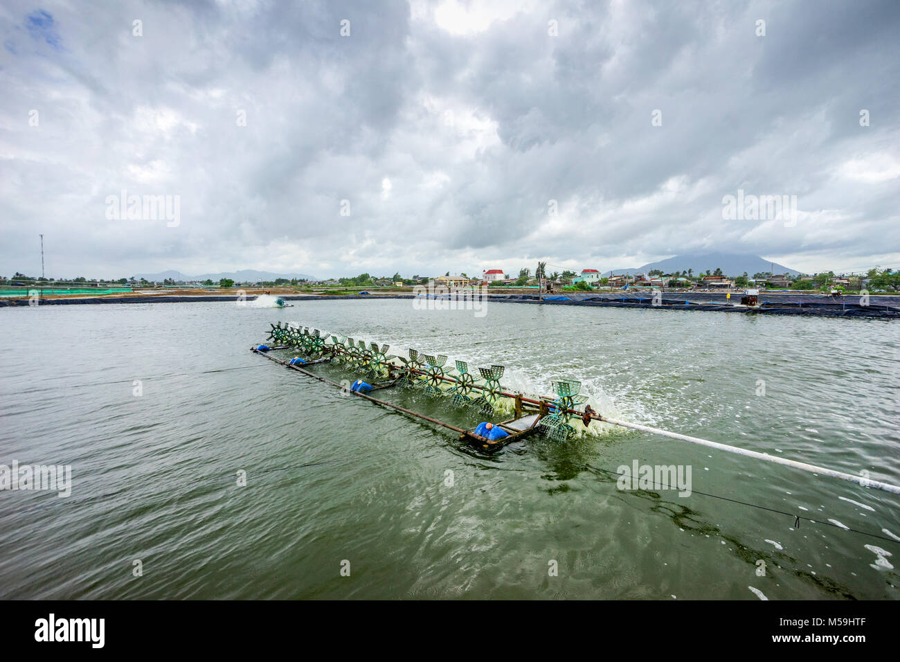 * Aerator turbine wheel oxygen fill ins Into lake water in Shrimp farm at Ba Ria, Vung Tau, Vietnam Stock Photo