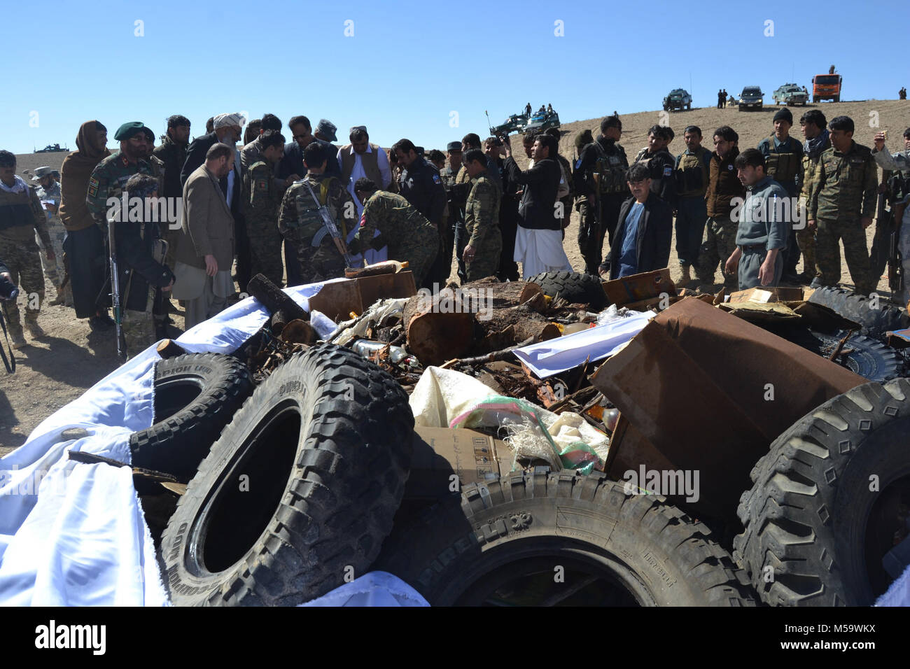 Zabul. 21st Feb, 2018. Afghan security force members and local officials stand beside seized drugs in Qalat, capital of Zabul province, Afghanistan. Afghan authorities have burned over 3 tons of seized narcotic drugs in southern province of Zabul, the provincial governor said on Wednesday. Credit: Arghand/Xinhua/Alamy Live News Stock Photo