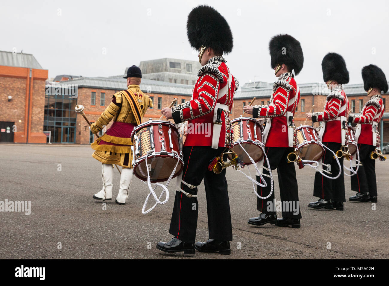 Windsor, UK. 21st February, 2018. Drum Major Liam Rowley leads the Drum Corps Coldstream Guards onto the parade ground to attend the Major General's Inspection of the 1st Battalion Coldstream Guards in preparation for the Queen's Birthday Parade. Soldiers are tested on military knowledge, history, values and standards and their uniforms, presentation and drill are minutely examined. Credit: Mark Kerrison/Alamy Live News Stock Photo