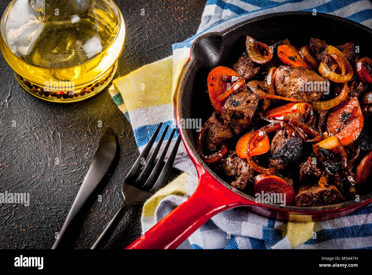 Roasted or grilled beef liver with onion and carrot in portioned frying