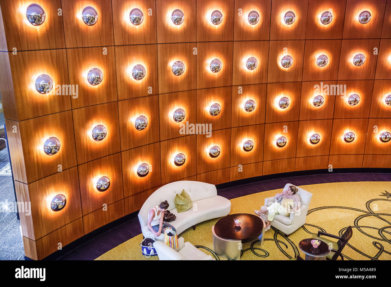 Miami Beach Florida,Ritz Carlton South Beach,hotel lobby,luxury,elegance,Morris Lapidus designed,MiMO,Miami Modern,cherry wood wall panel,backlit conv Stock Photo