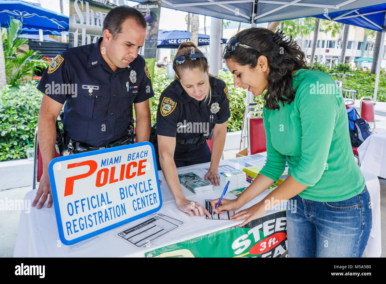 Miami Beach Florida,Lincoln Road,Bike to Work Week,police officer,man men male,woman female women,bicycle,bicycling,riding,biking,rider,bike registrat Stock Photo