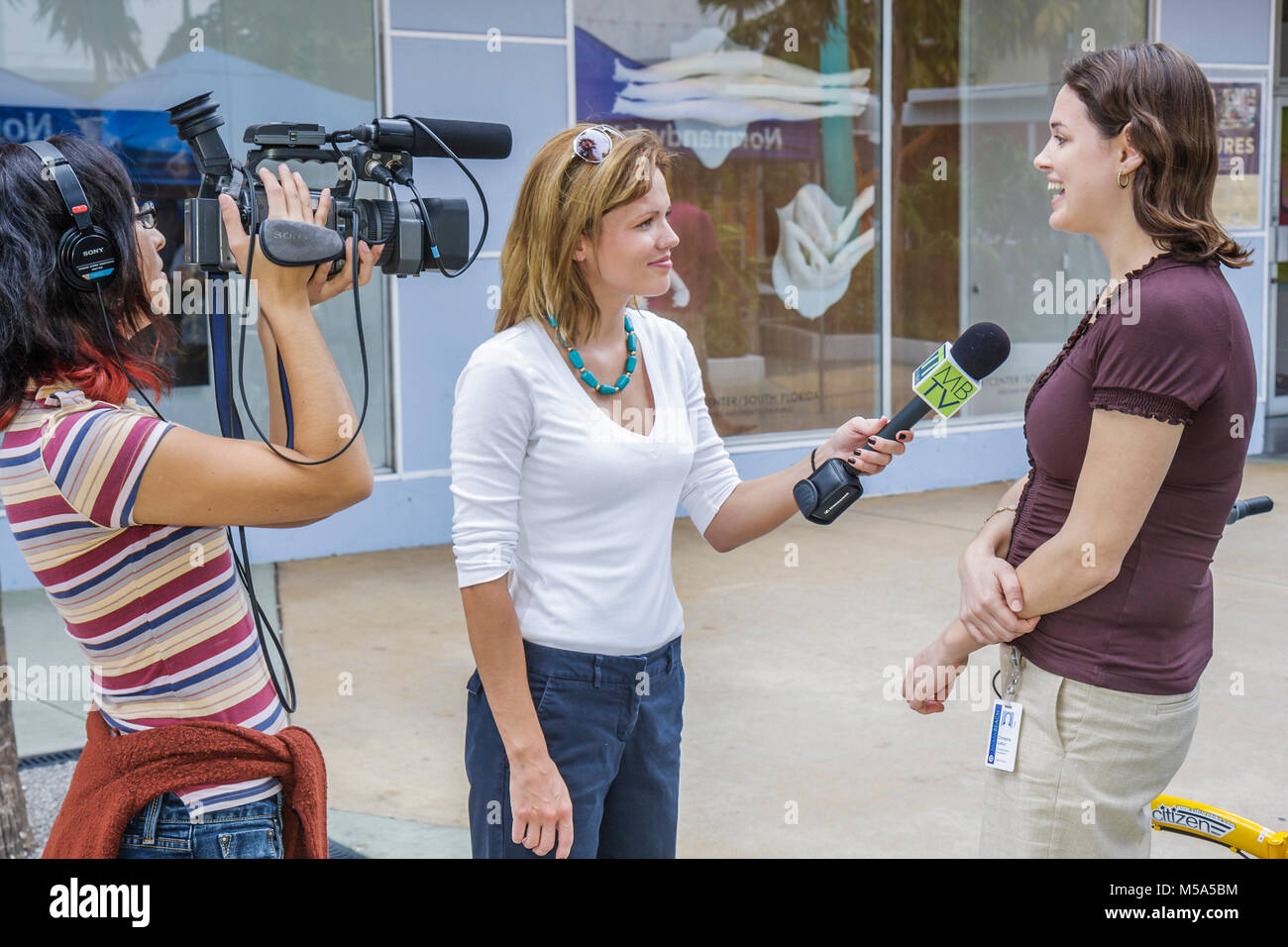 Miami Beach Florida,Lincoln Road,woman female women,videographer video camera interviews interviewing media TV television city,community cable station Stock Photo