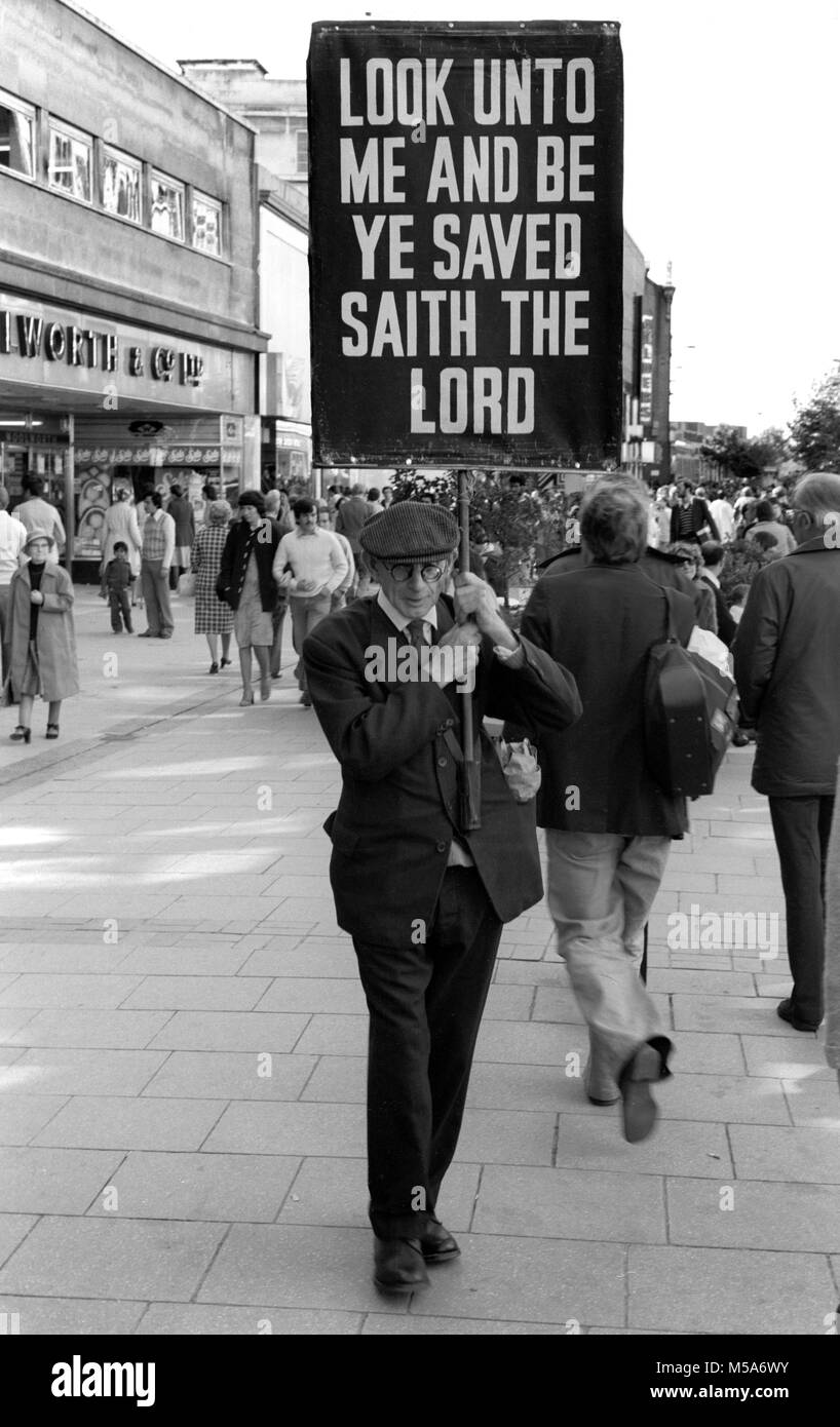 UK, Wales, Cardiff, City Centre, Queen Street, religious campaigner holding banner aloft in 1970s Stock Photo