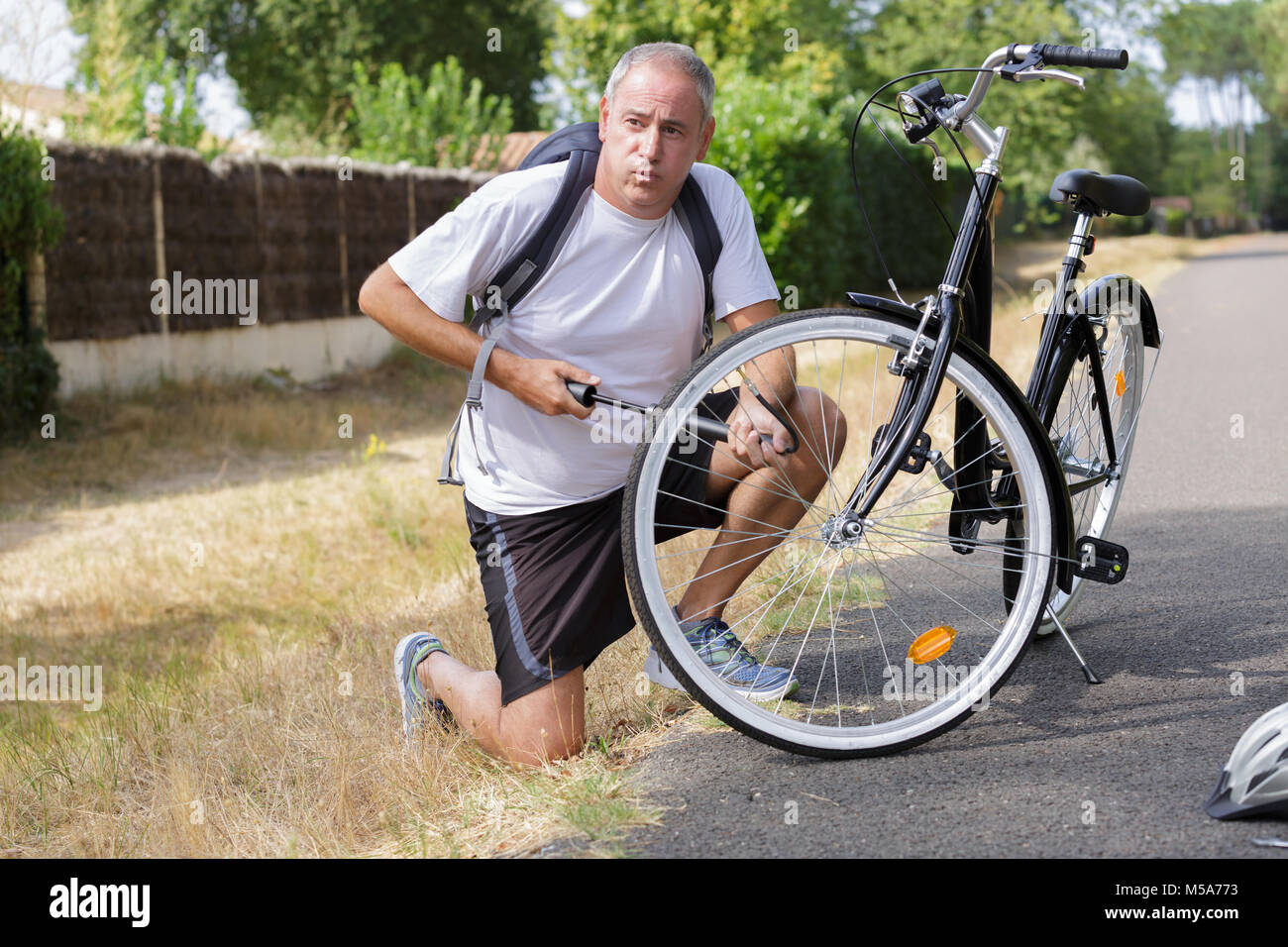 pumping up a bike tire