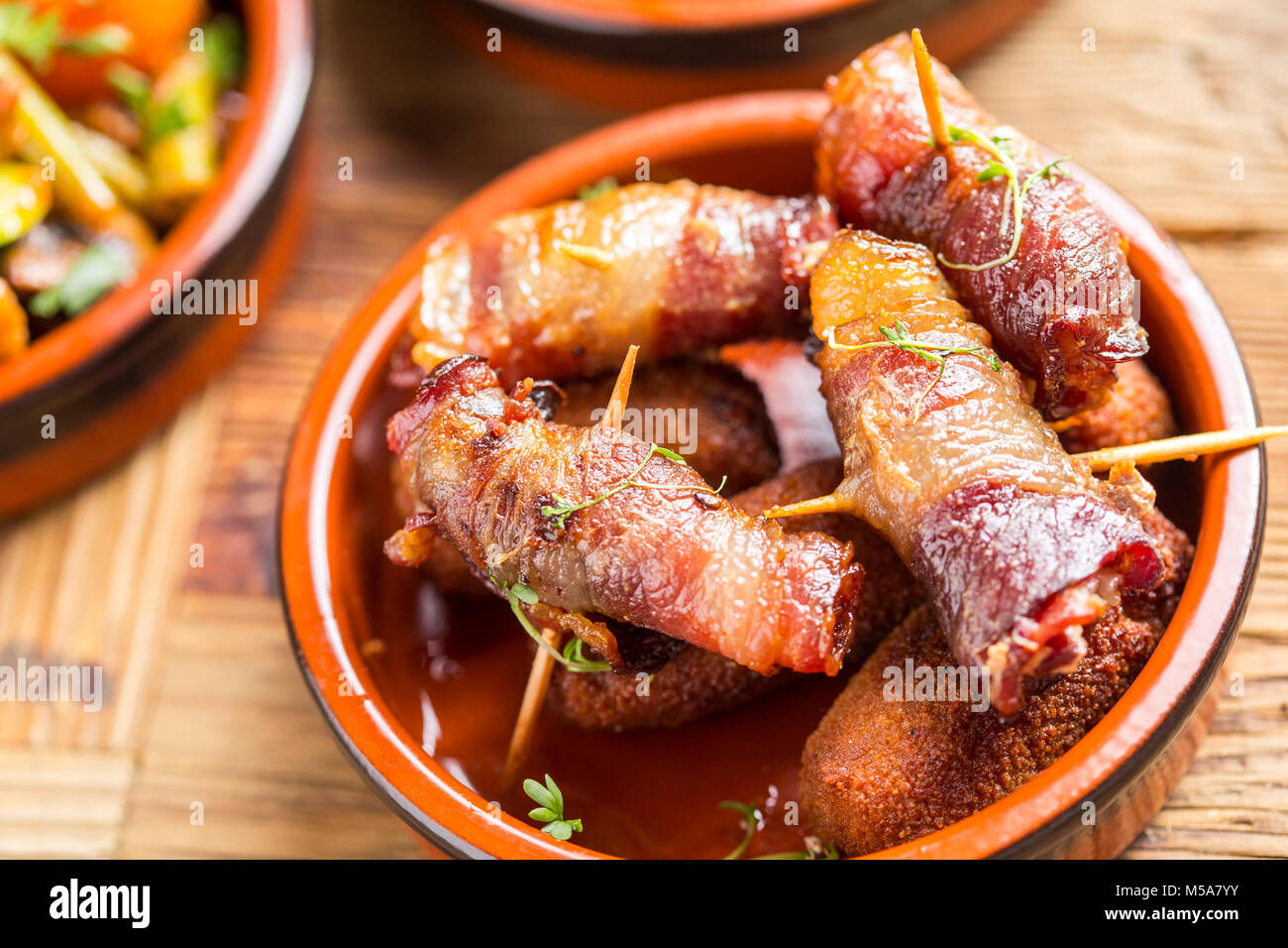 delicious rustic spanish mediterranean dates in ham tapas starter Stock Photo