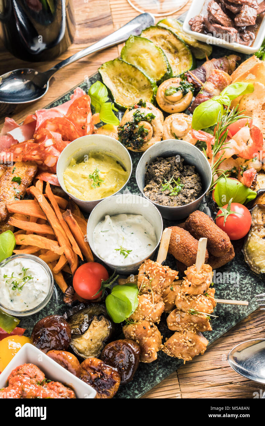 delicious giant rustic starter dish plate with antipasti dips bread tapas Stock Photo