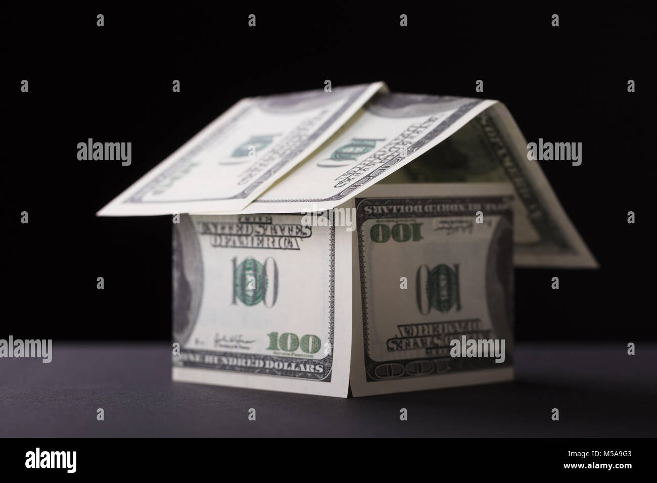 Close-up Of A House Made Up Of Banknote On Black Background Stock Photo ...