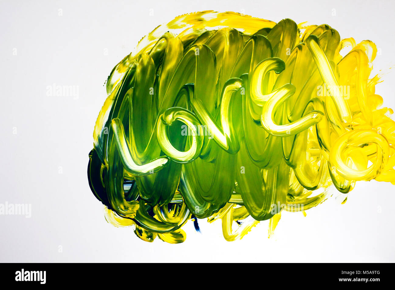 Painted Love in swirling bright colours on white background Stock Photo