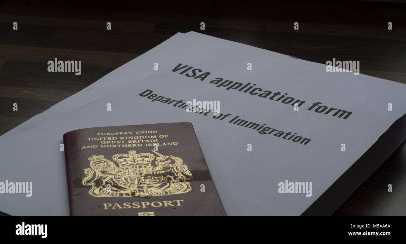 A Visa application form with a British passport on top of it (Applying for a visa concept) Stock Photo