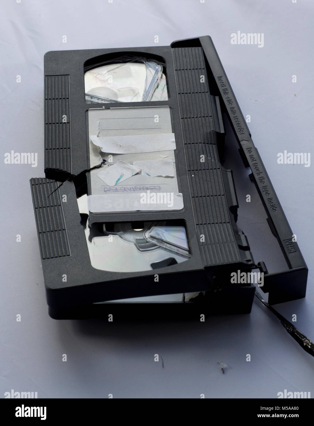 An old VHS cassette which has been destroyed beyond repair (death of home video concept) Stock Photo