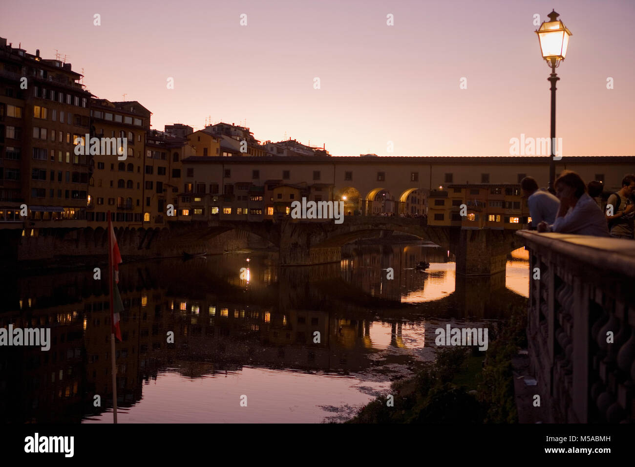 Dusk over the river Arno in Florence, with the Ponte Vecchio spanning the river Stock Photo