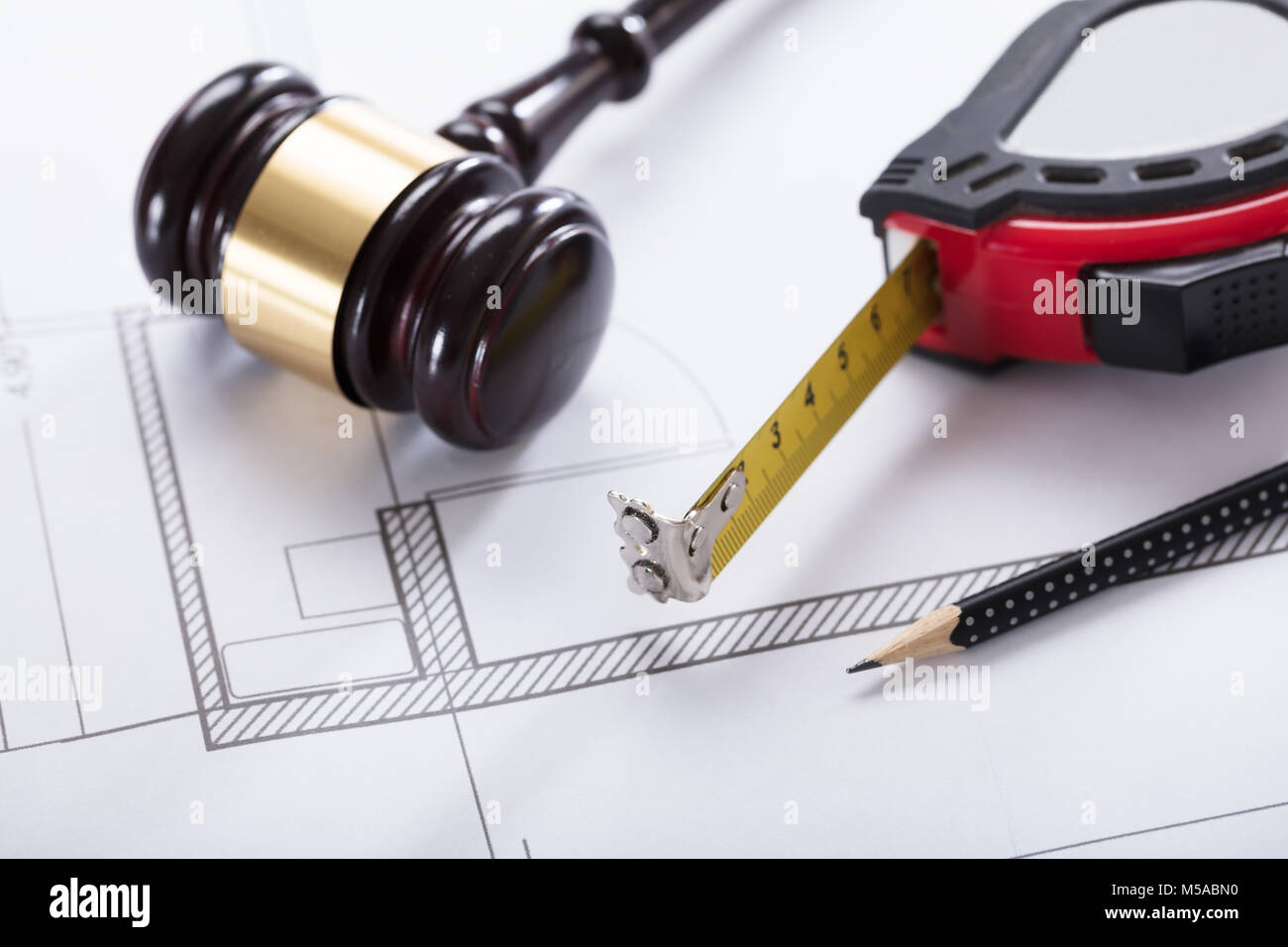 Close-up Of Gavel, Measuring Instrument And Pencil On Blueprint Stock Photo