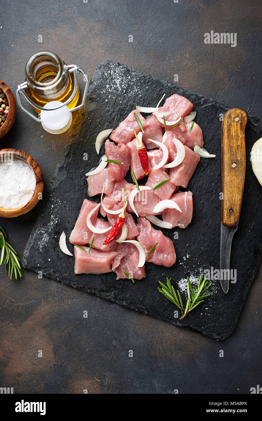 Raw chopped meat with spices on rusty background Stock Photo
