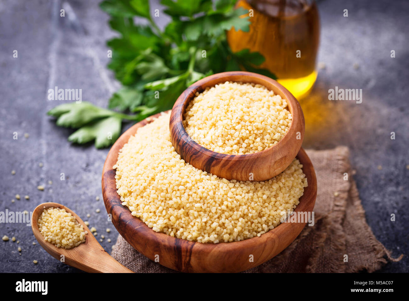 Couscous grain in wooden bowl Stock Photo Alamy