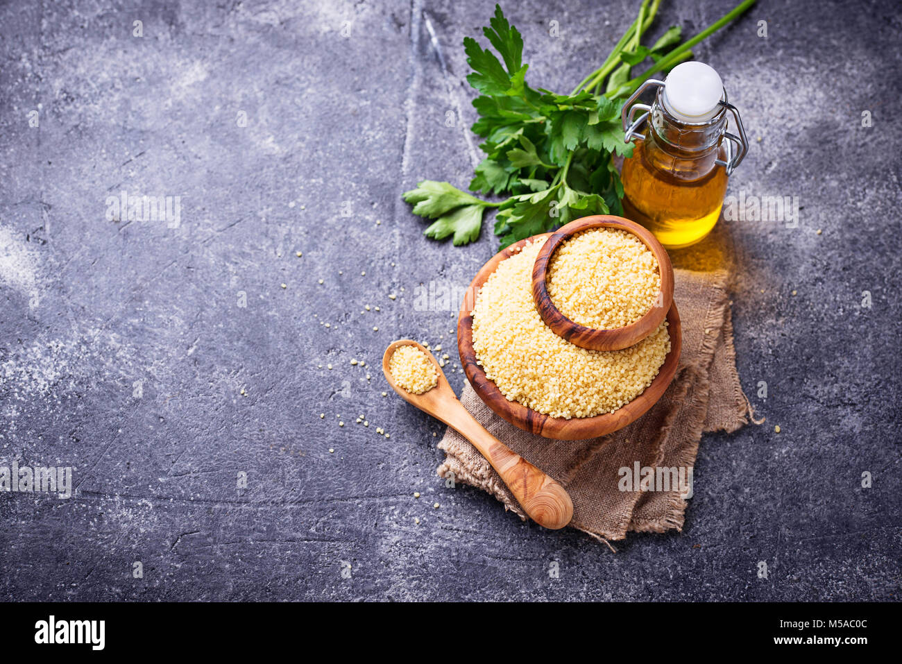 Couscous grain in wooden bowl Stock Photo Alamy
