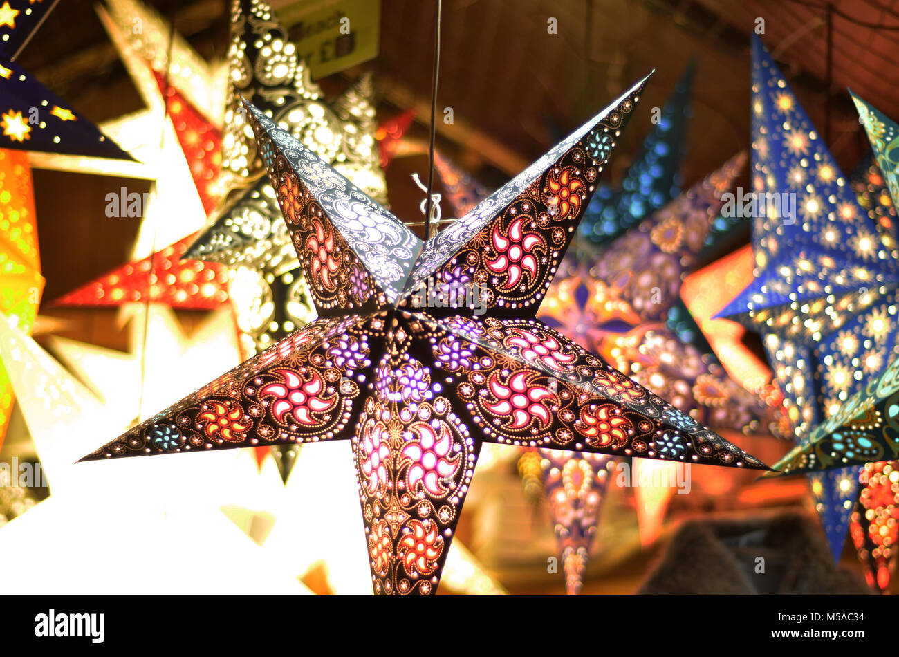 Christmas lantern stars on stall Stock Photo