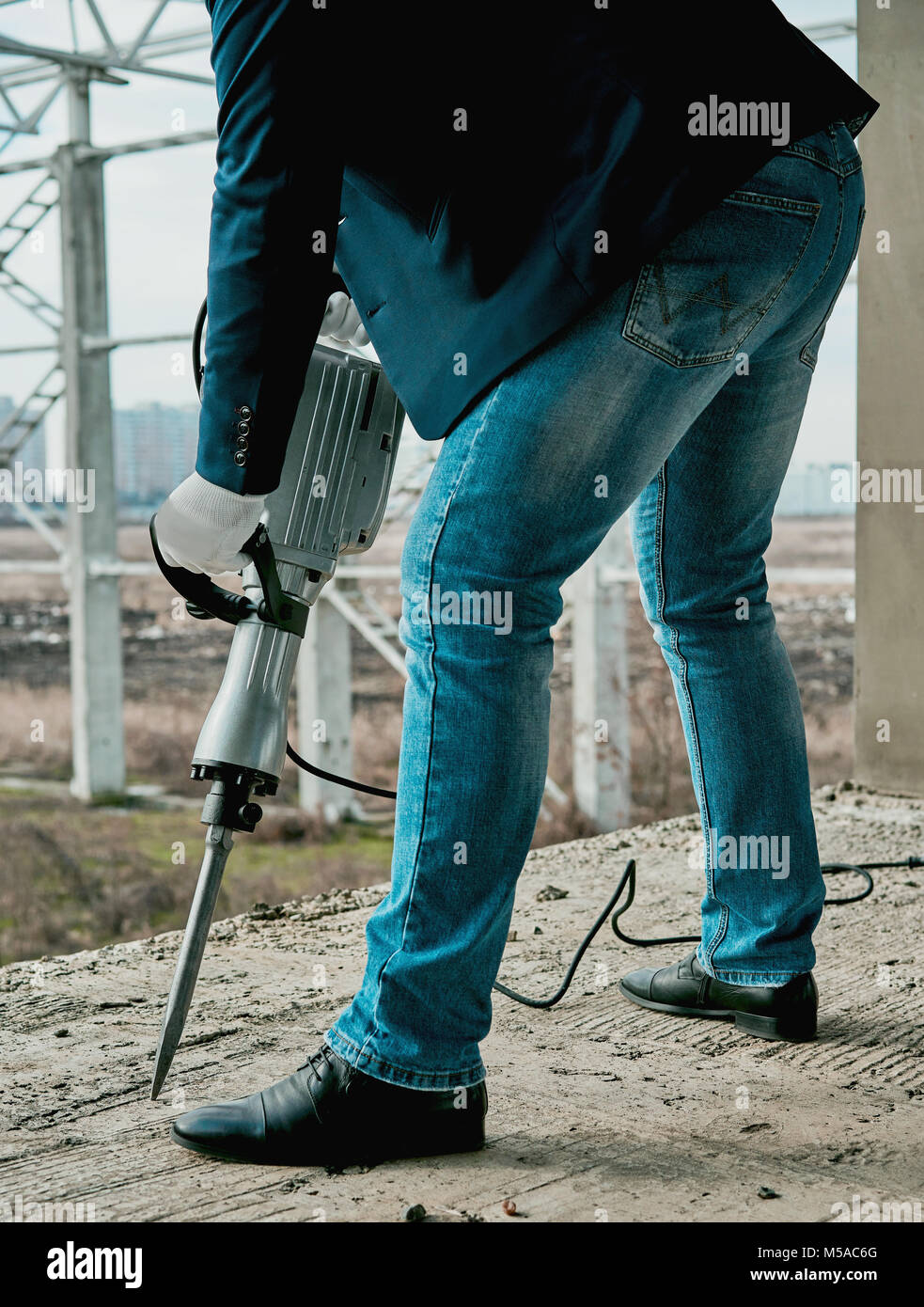 man with a jackhammer at a construction site Stock Photo