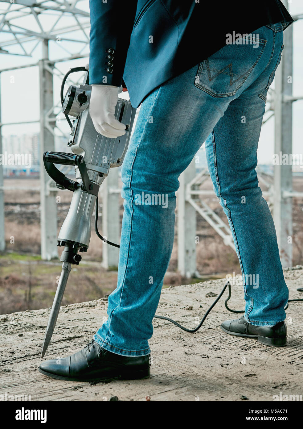 man with a jackhammer at a construction site Stock Photo