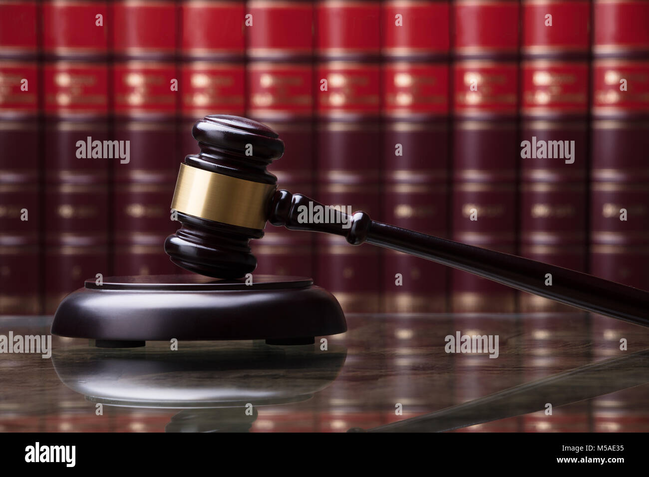 Close-up Of A Wooden Gavel In Front Of Law Book Stock Photo