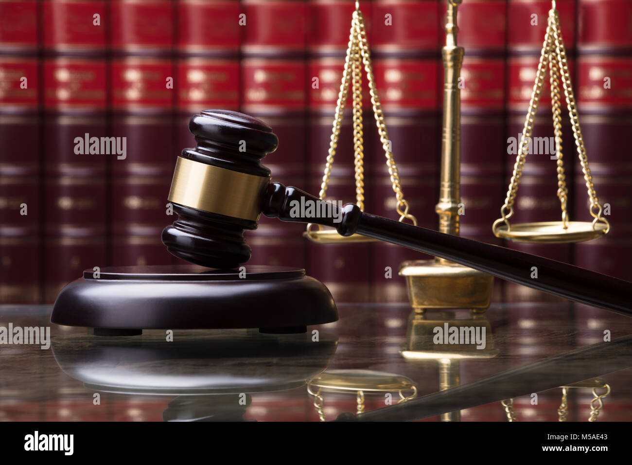 Close-up Of Gavel And Golden Weighing Scale In Courtroom Stock Photo