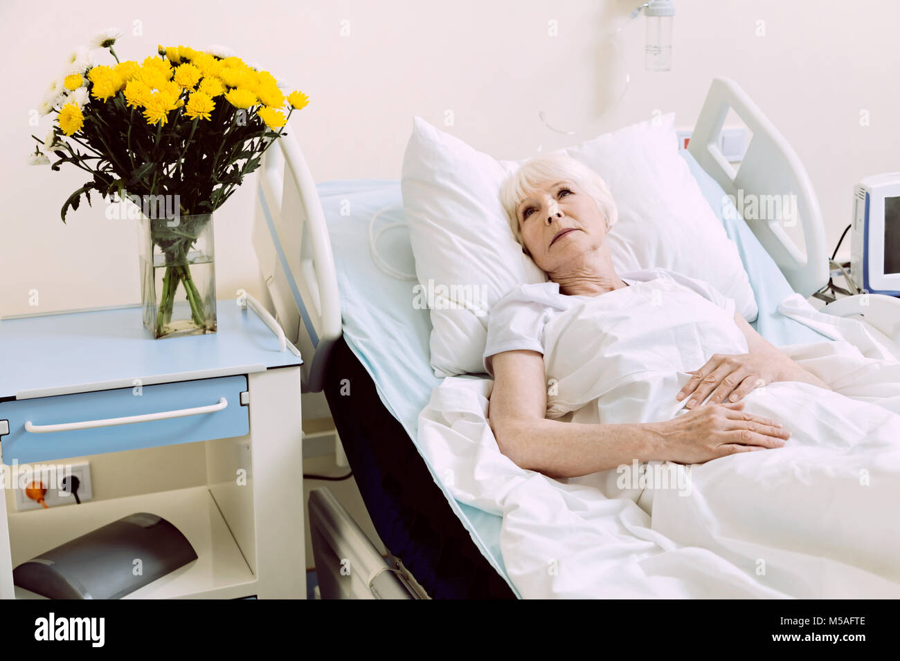 Pensive senior lady lying in hospital bed Stock Photo Alamy