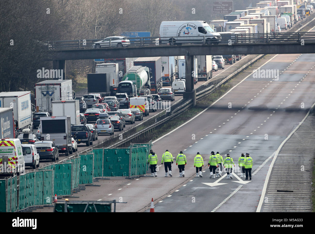 Police officers at work on the M20 near Ashford in Kent which has been closed to traffic after a body was found on the road yesterday evening. Stock Photo
