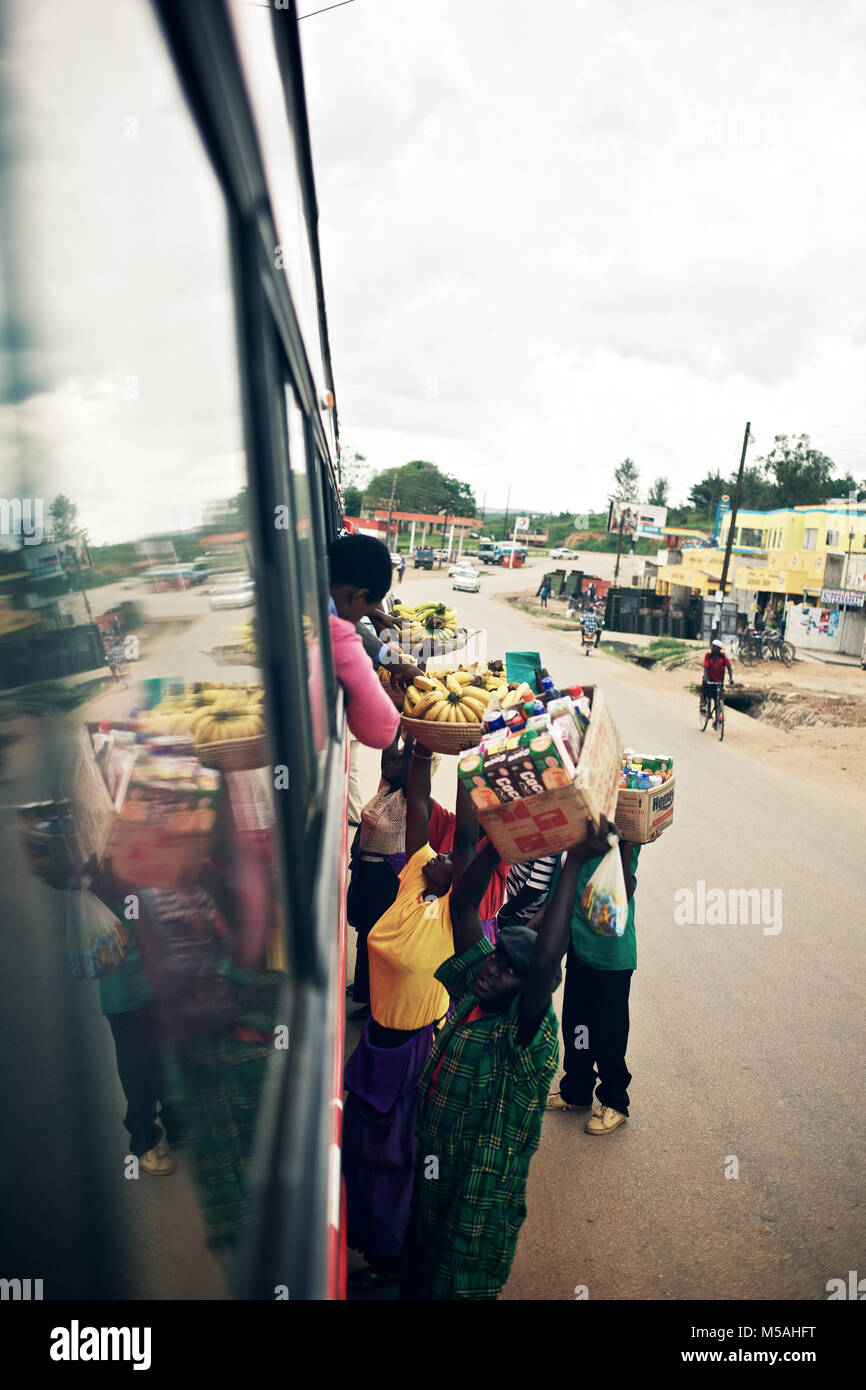 Uganda - September 15, 2011: A person is buying goods from the bus on the way from Kampala to Kabale. Stock Photo